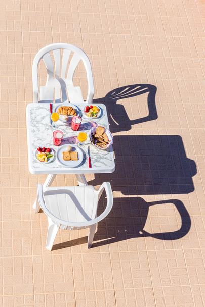 Food for breakfast on table at terrace - Zdjęcie, obraz