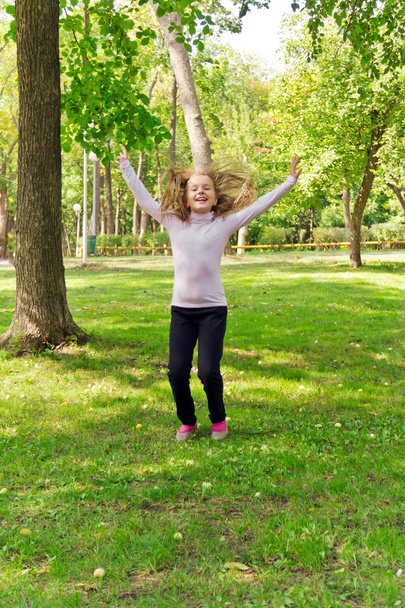Jumping girl in summer - Фото, изображение