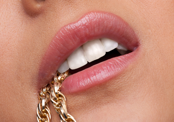 Beauty woman lips desired with gold chain - Fotó, kép