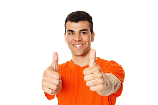 Smiling man gesturing humbs up - 写真・画像