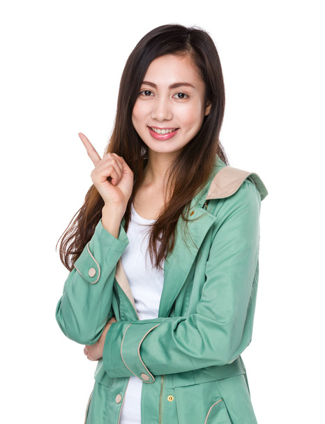 Asian young woman in green coat - Foto, afbeelding