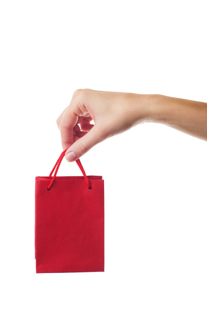 Female hand holding red gift bag - Φωτογραφία, εικόνα