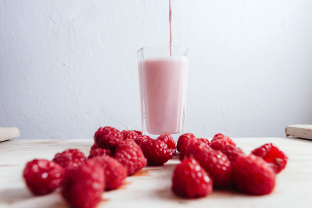 Raspberry smoothie vers gemengd op zomer houten tafel - Foto, afbeelding