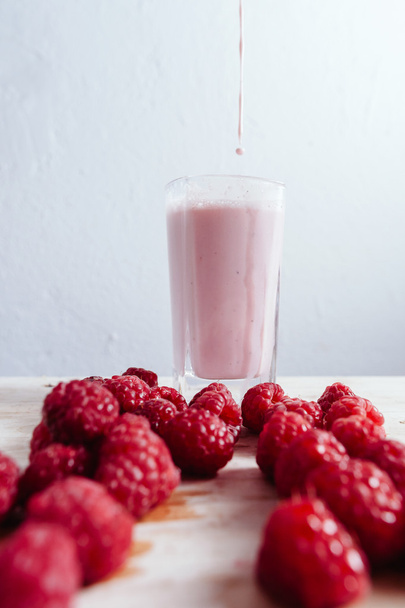 Raspberry smoothie fresh blended on summer wood table - Zdjęcie, obraz