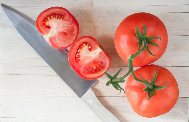 Freshly sliced tomato with knife - Photo, Image