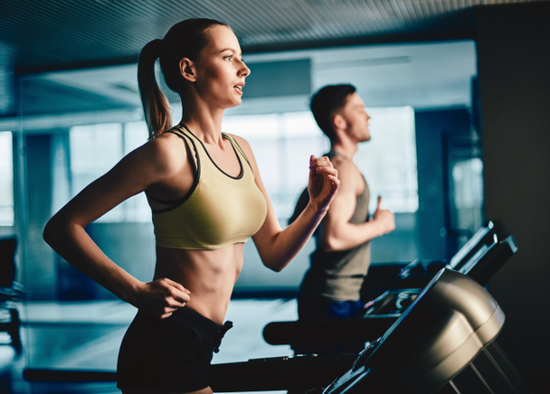 woman and man running on treadmill - Photo, Image