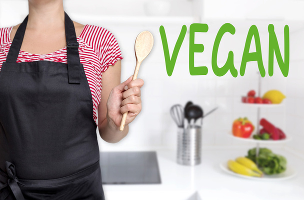 vegan chef holding wooden spoon background - Zdjęcie, obraz
