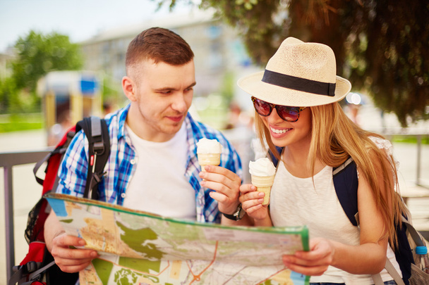 tourists with ice-cream looking at map - Photo, Image