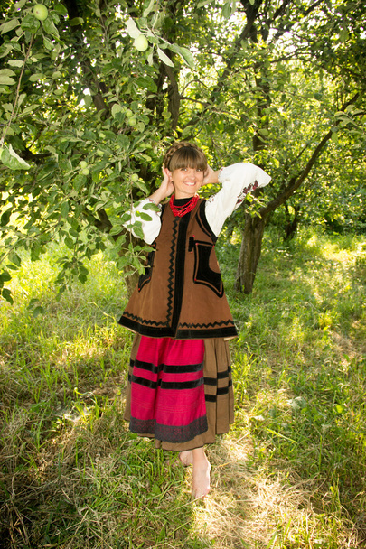 young girl, Ukrainian national costume, standing barefoot on the - Zdjęcie, obraz