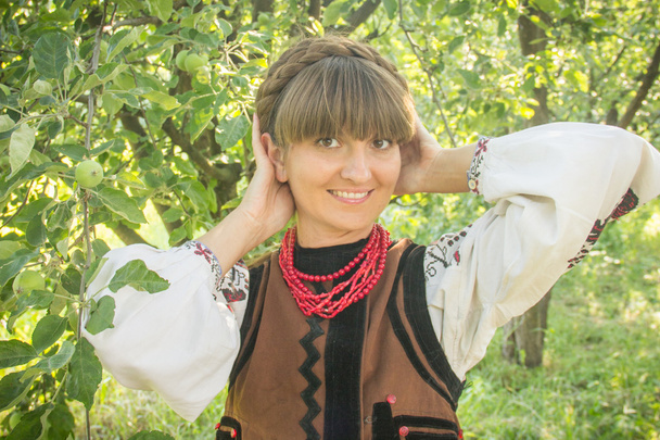 young girl, Ukrainian national costume, standing barefoot on the - Фото, зображення