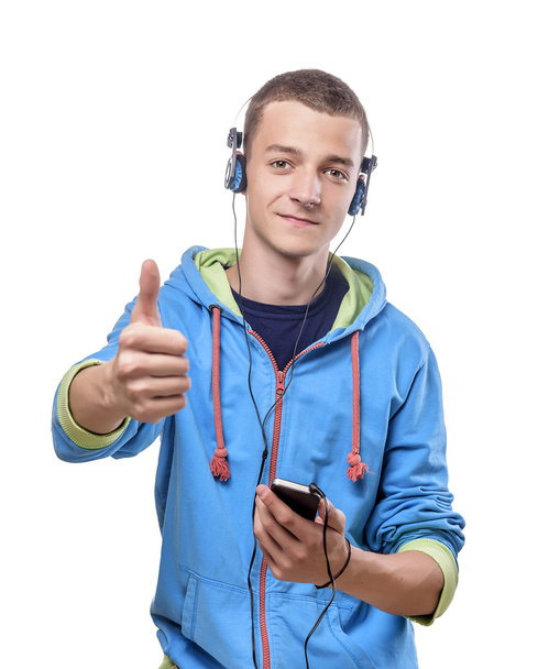 Guy using phone with headphones - 写真・画像