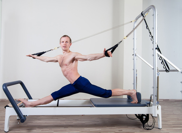 Pilates reformer workout exercises man at gym indoor - Foto, immagini