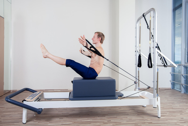 Pilates reformer workout exercises man at gym indoor - Fotoğraf, Görsel