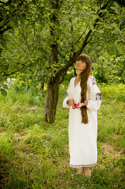 young girl in the Ukrainian embroidered shirt, standing barefoot - Φωτογραφία, εικόνα