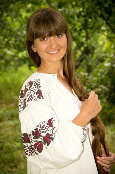 young girl in the Ukrainian embroidered shirt, standing barefoot - Φωτογραφία, εικόνα