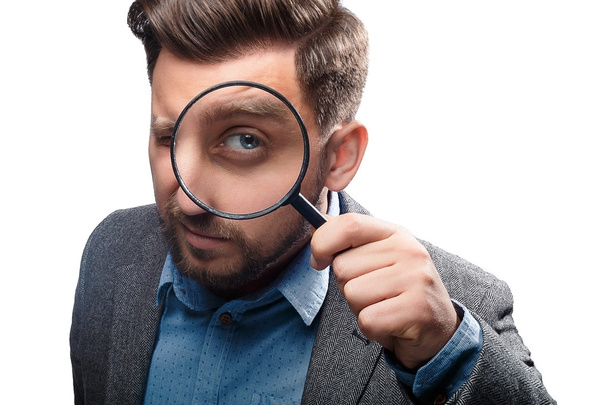 Man with magnifying glass on white background - Foto, Imagem