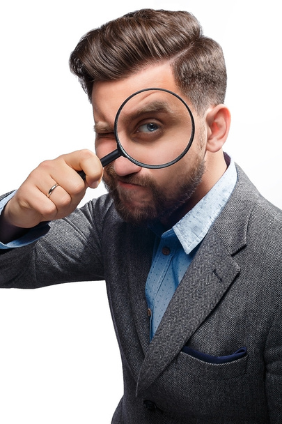 Man with magnifying glass on white background - Φωτογραφία, εικόνα