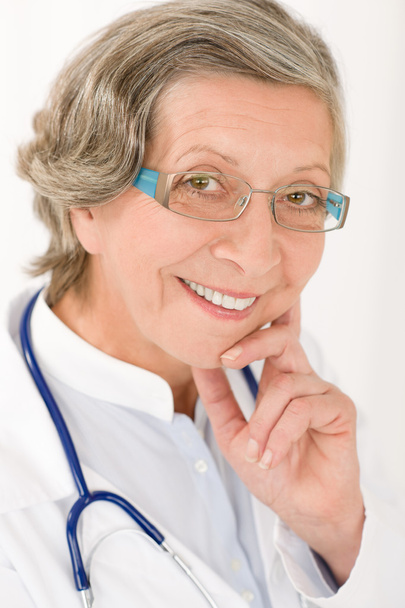 Senior doctor female with stethoscope smiling - Foto, imagen