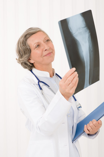 Senior doctor female happy hold x-ray - Foto, imagen