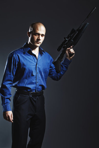 Handsome young man holding a gun - Photo, Image