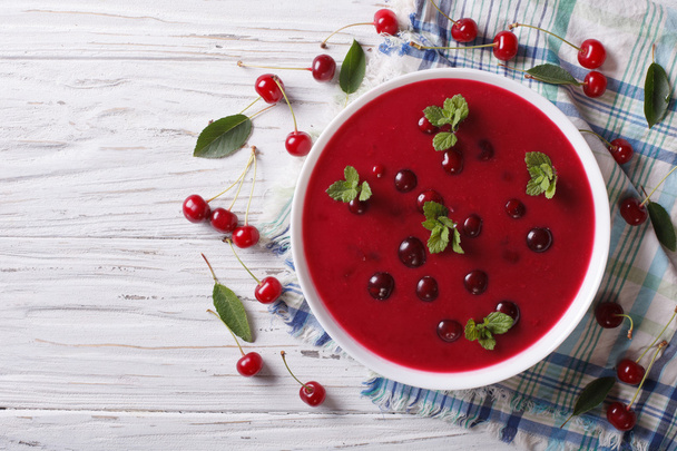 Hungarian cold cherry soup on the table. Horizontal top view  - 写真・画像