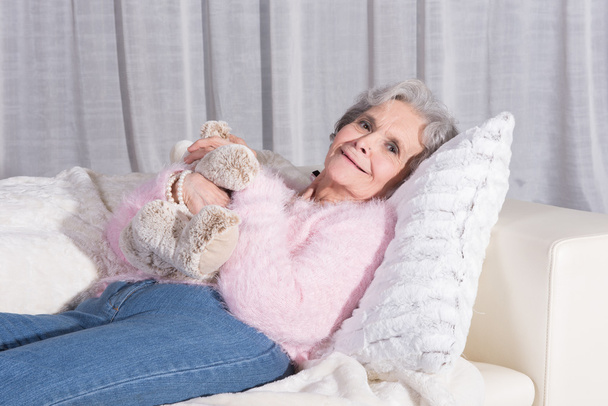 active female senior relaxing on couch - Fotografie, Obrázek