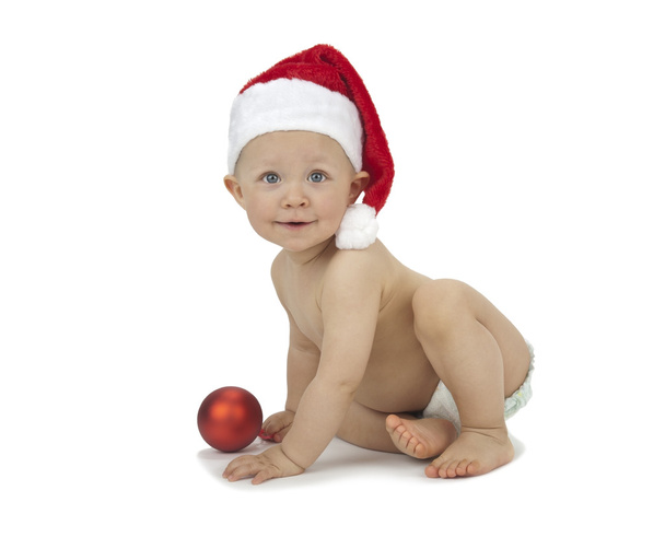 Child with Christmas decoration and Santa hat - Фото, зображення