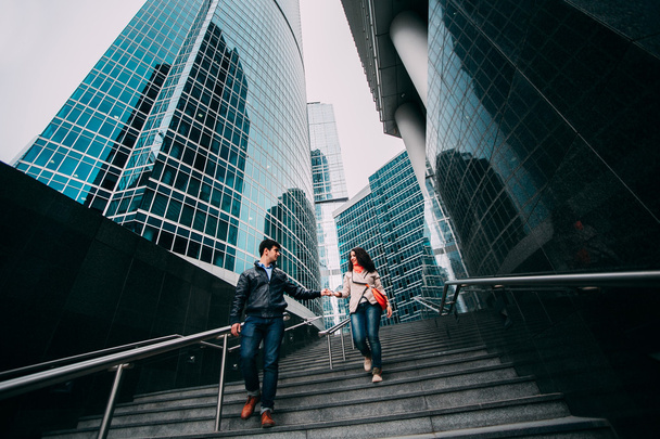 Young couple walking near the skyscrapers in Moscow - Foto, afbeelding