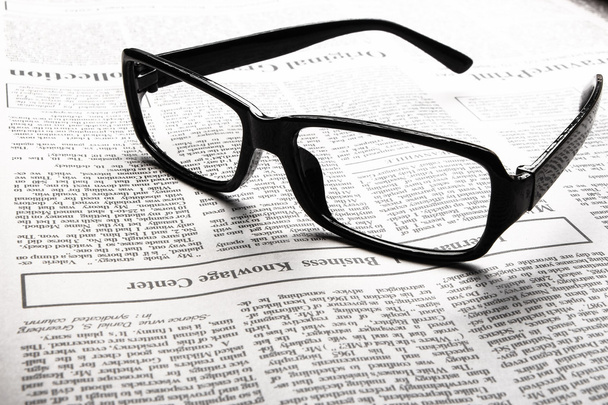 Glasses on newspaper - Фото, изображение