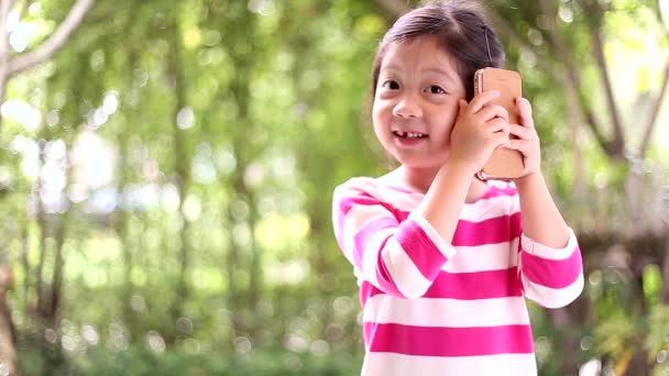 Little Girl Talking on Smartphone or Cell Phone with Happiness - Video