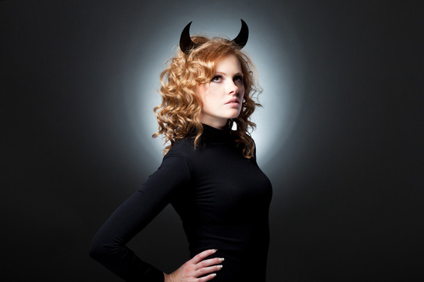 The beautiful young girl a devil - Foto, afbeelding