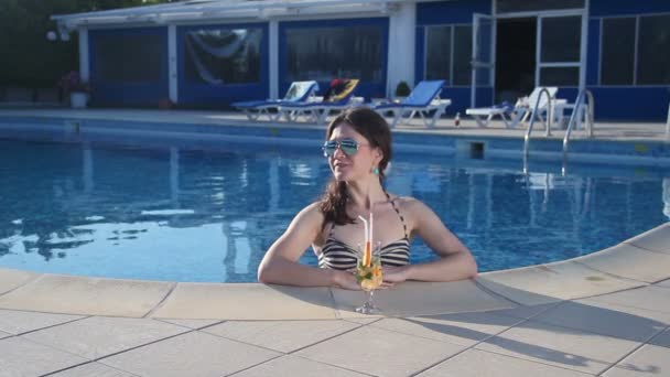 Happy woman enjoying fresh cocktail in water on luxury beach - Кадри, відео