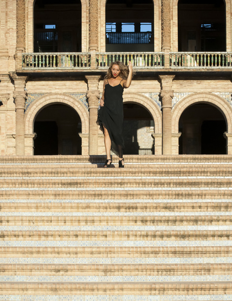 Beautiful woman on stairs in a monumental area - Photo, Image