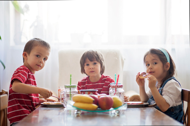 Three happy kids, two brothers and little sister, having healthy - Valokuva, kuva