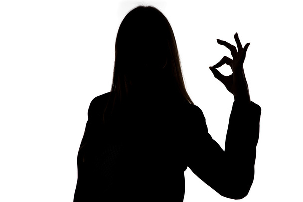 Silhouette of woman showing okay  - Photo, Image