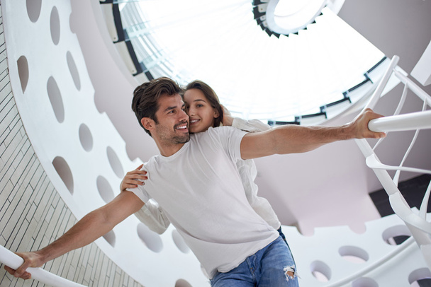 Relaxed young couple at home stairs - Foto, Bild