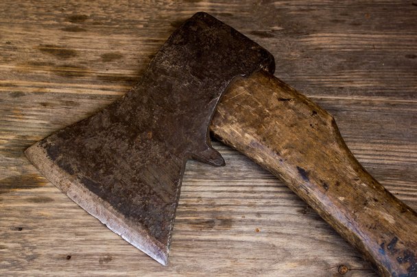 Old ax on a wooden background. top view. - Photo, Image
