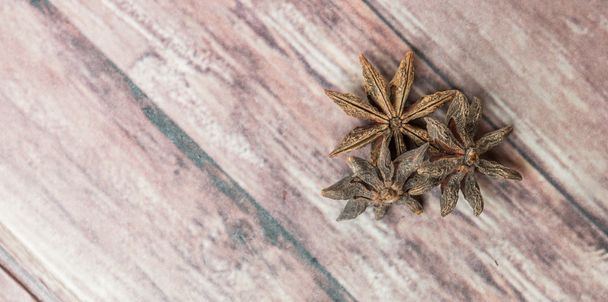 Star anise spices over weathered wooden background - Fotó, kép