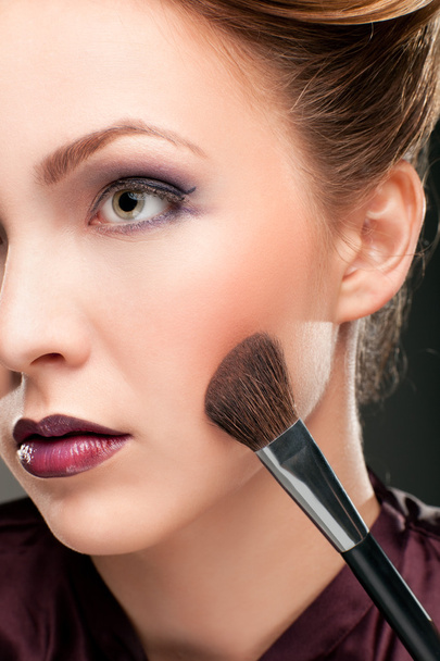 Beautiful woman with makeup brush - Foto, imagen