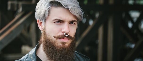 Bearded hipster with nose ring in leather jacket - Zdjęcie, obraz