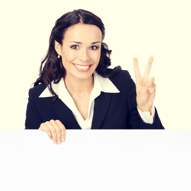 smiling businesswoman with blank signboard, showing two fingers - Photo, image