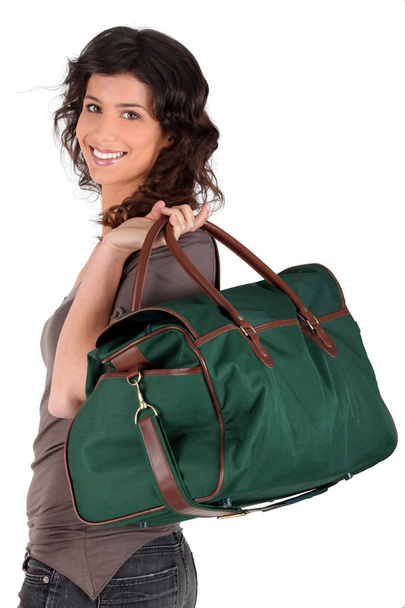 Young woman smiling with travel bag - Фото, зображення
