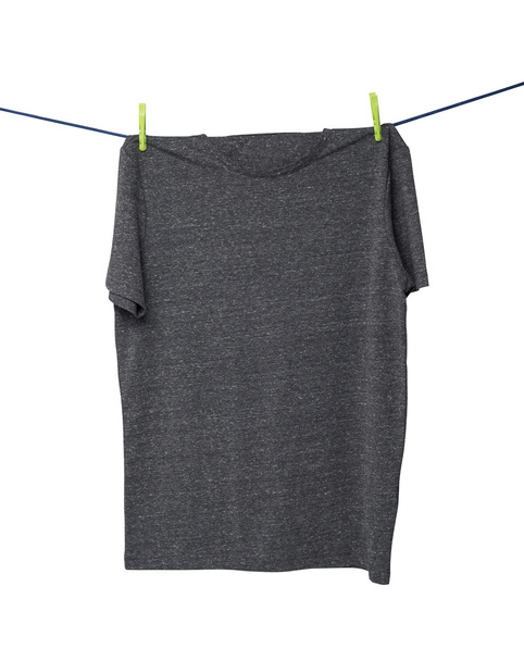 Close up of a dark grey t-shirts on the rope. Isolated. - 写真・画像