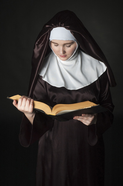 Nun with bible. - Zdjęcie, obraz