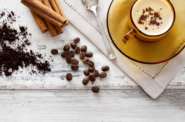 Kaffeetasse und Bohnen auf einem Holztisch - Foto, Bild