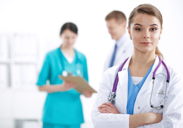 Attractive female doctor in front of medical group - Foto, afbeelding