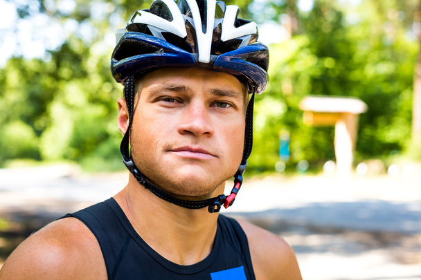 Professional cyclist smiling with helmet on the head for safety - Foto, immagini