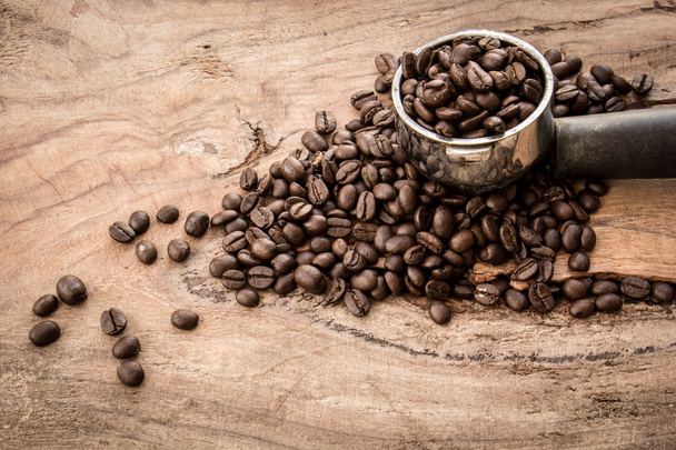 Geroosterde Columbiaanse koffie bonen geplaatst op een houten tafel. - Foto, afbeelding