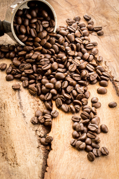 Roasted Columbian coffee beans placed on a wooden table. - Foto, immagini