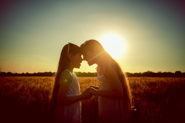 little sisters are twins to meet sunset - 写真・画像